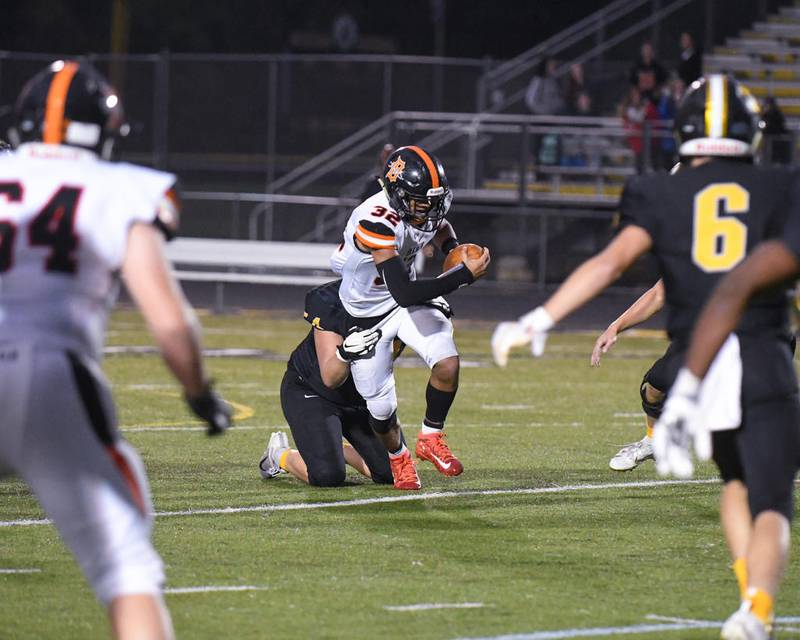 DeKalb Trenton McCollum (32) gains yards before getting tied up by a Metea Valley player in the second quarter Sept. 27th