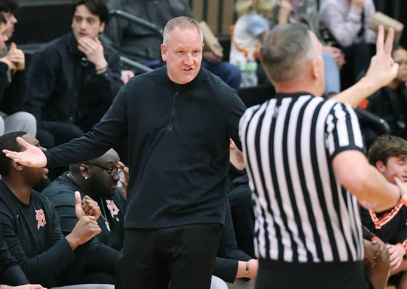 DeKalb head coach Mike Reynolds questions an official during their game against Waubonsie Valley Friday, Dec. 15, 2023, at DeKalb High School.