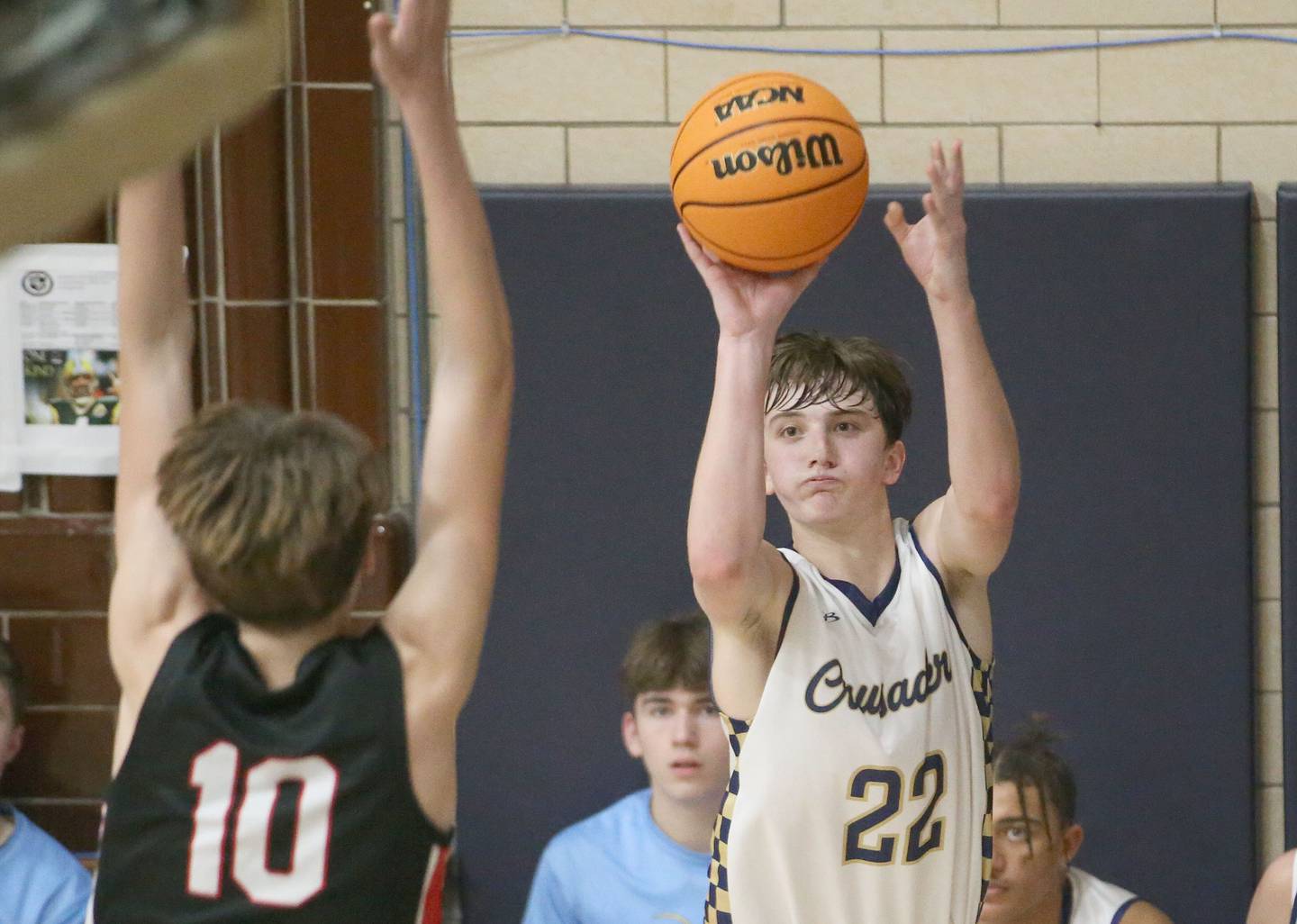 Marquette's Griffin Dobberstein lets go of a shot over Earlville's Easton Fruit on Friday, Jan. 3, 2025 in Bader Gym at Marquette High School.