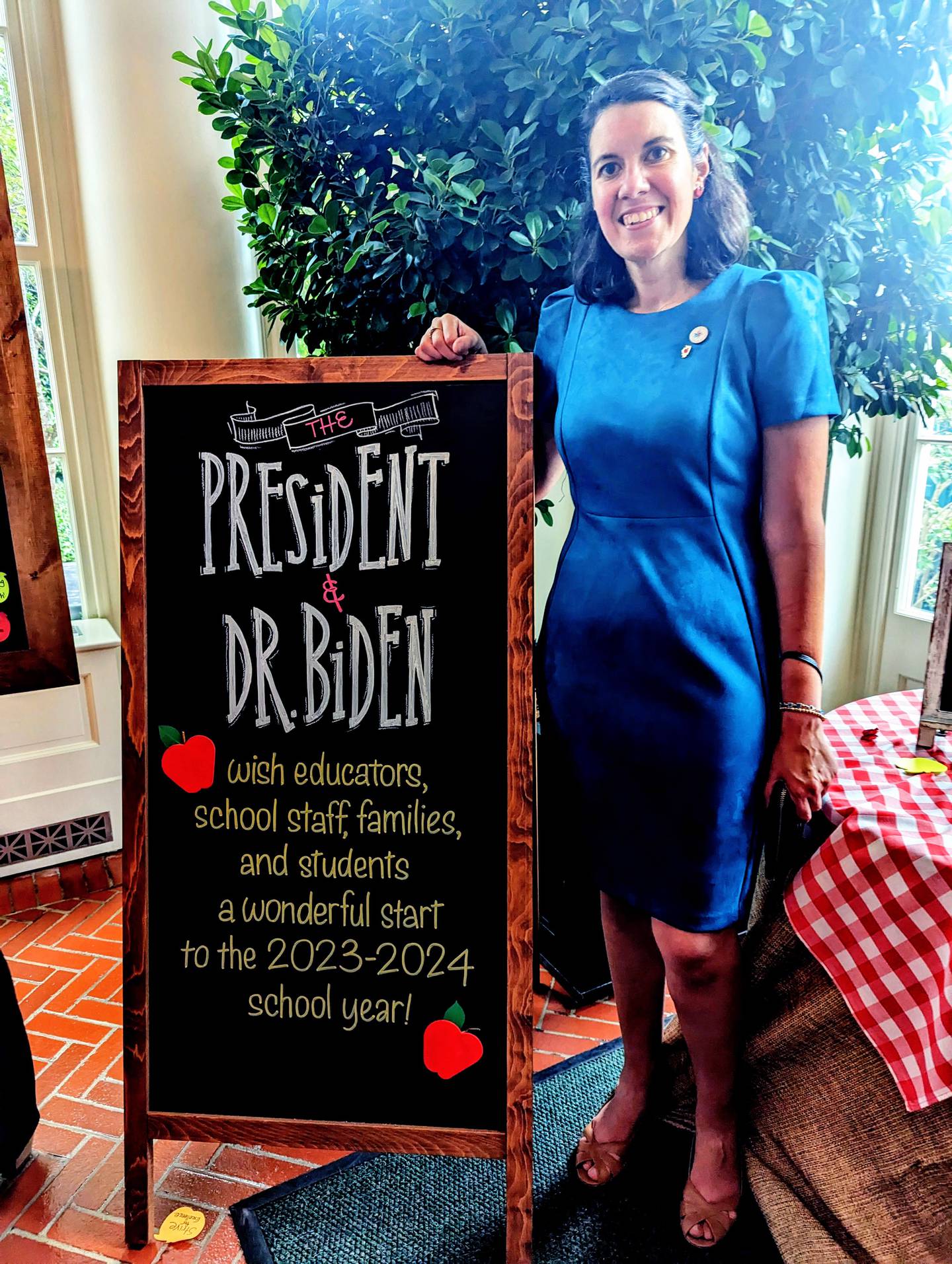 Kimberly Radostits poses next to a sign in the White House during an Aug. 26 back-to-school event. Radostits teaches high school Spanish at Oregon Junior-Senior High School and was the 2022 Illinois Teacher of the Year.