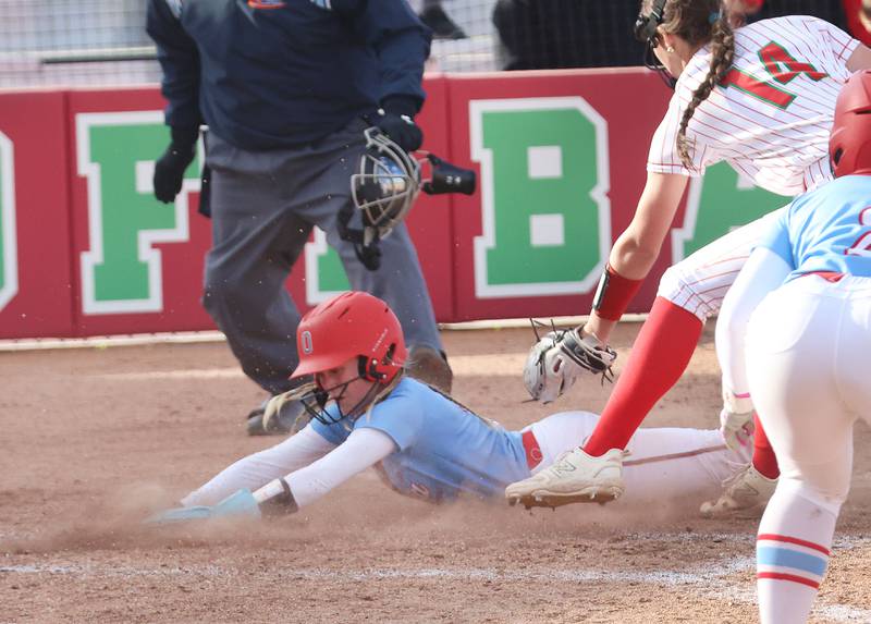 Ottawa's Rylee Harsted slides in safely to home on a passed ball as L-P's Brianna Ruppert misses the tag on Wednesday, April 29, 2026 at the L-P Athletic Complex in La Salle.