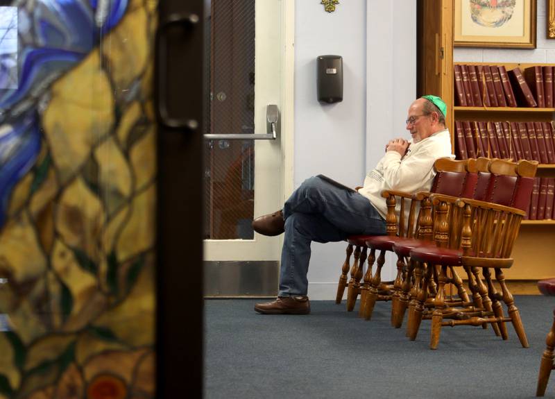 Louis Dolmon of Woodstock listens to traditional songs during a Chanukah party at The McHenry County Jewish Congregation Sunday. Dolmon has been a member of the congregation since 1985.