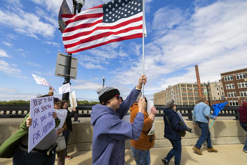 Organized by Indivisible SRFD, a group marches across the First Avenue bridge into Sterling Saturday, May 3, 2025, to protest the Trump administration and show their support for workers’ rights. The crowd started at RB&W Park in Rock Falls and marched to Grandon Civic Center in Sterling.