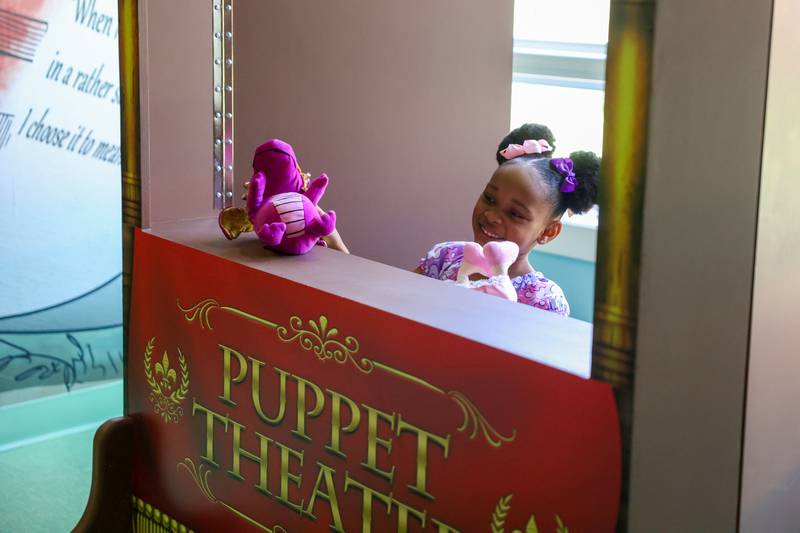 Maria Johnson, 5, of Bourbonnais, puts on a puppet show for her mom, Sherise, in the Exploration Station's new Storybook Forest exhibit on Monday, June 23, 2025, during its grand opening event.