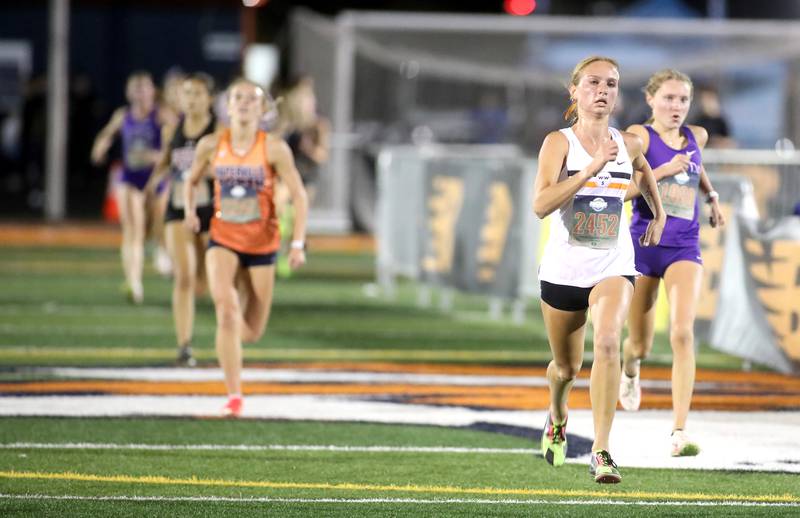 Wheaton Warrenville South’s Nicole Poglitsch runs to the finish in the varsity girls race during the Naperville North Twilight Cross Country Invitational on Wednesday, Oct. 9, 2024 in Naperville.