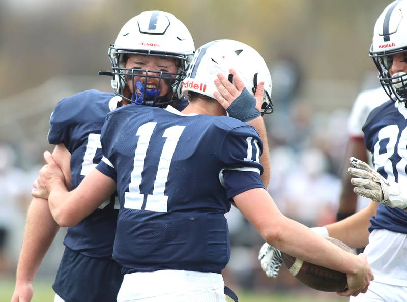 Cary-Grove’s Peyton Seaburg (11) is greeted by teammate Ethan Hammer after a touchdown against Antioch in IHSA Class 6A second-round playoff football action on Saturday, Nov. 9, 2024, at Al Bohrer Field on the campus of Cary-Grove High School in Cary..