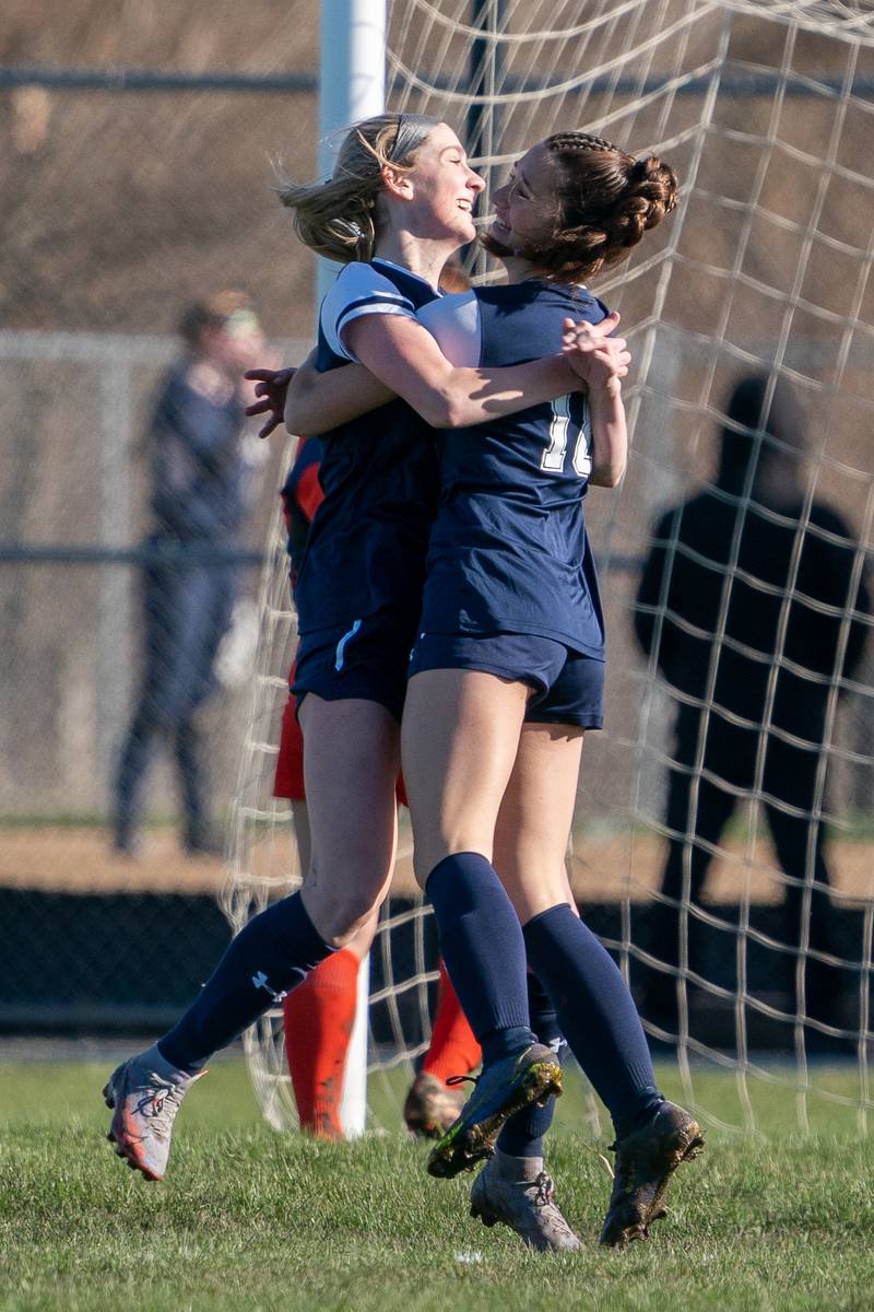 After scoring a goal against Oswego, Oswego East's Erika Smiley (left) hugs Ashley Gumm during a soccer match at Oswego East High School on Thursday, Apr 6, 2023.