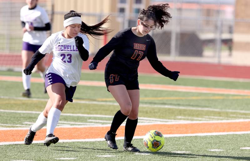 DeKalb's Natalie Delgado tries to hold off Rochelle's Lucy Monroy during their game Thursday, April 14, 2022, at DeKalb High School.