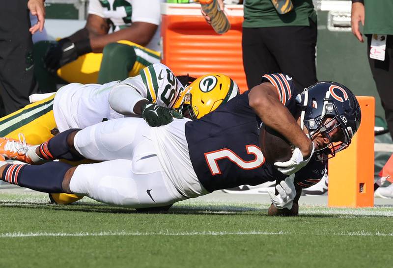 Chicago Bears wide receiver DJ Moore carries Green Bay Packers linebacker De'Vondre Campbell for a first down during their game Sunday, Sept. 10, 2023, at Soldier Field in Chicago.