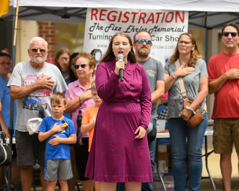 Recent Sycamore graduate and Kishwaukee College student Anabelle Christensen sings the national anthem during the 24th annual Fizz Ehrler Memorial Turning Back Time Car Show held in downtown Sycamore on Sunday, July 28, 2024.