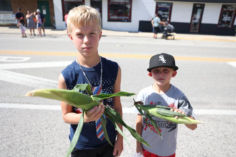 Carson Chambers, 10-years old, and Kim Kavanaugh, 7-years old, show off their corn they got at the Manhattan Labor Day Parade on Monday, Sept. 4, 2023 in Manhattan.
