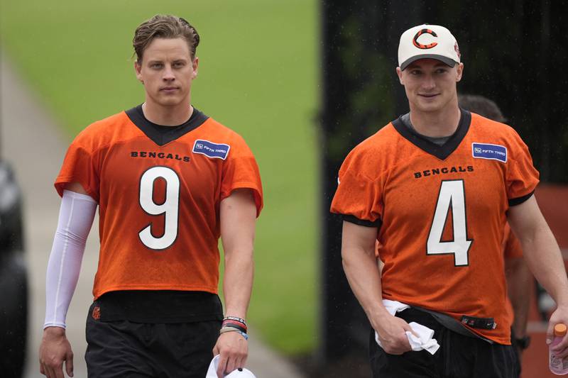 Cincinnati Bengals quarterbacks Joe Burrow (9), and Rocky Lombardi (4) walk from practice fields after the NFL football team's practice on Tuesday, May 14, 2024, in Cincinnati. (AP Photo/Carolyn Kaster)