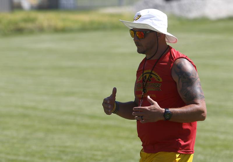 Coach Brian Zimmerman talks to his players during football practice Monday, June 20, 2022, at Jacobs High School in Algonquin.