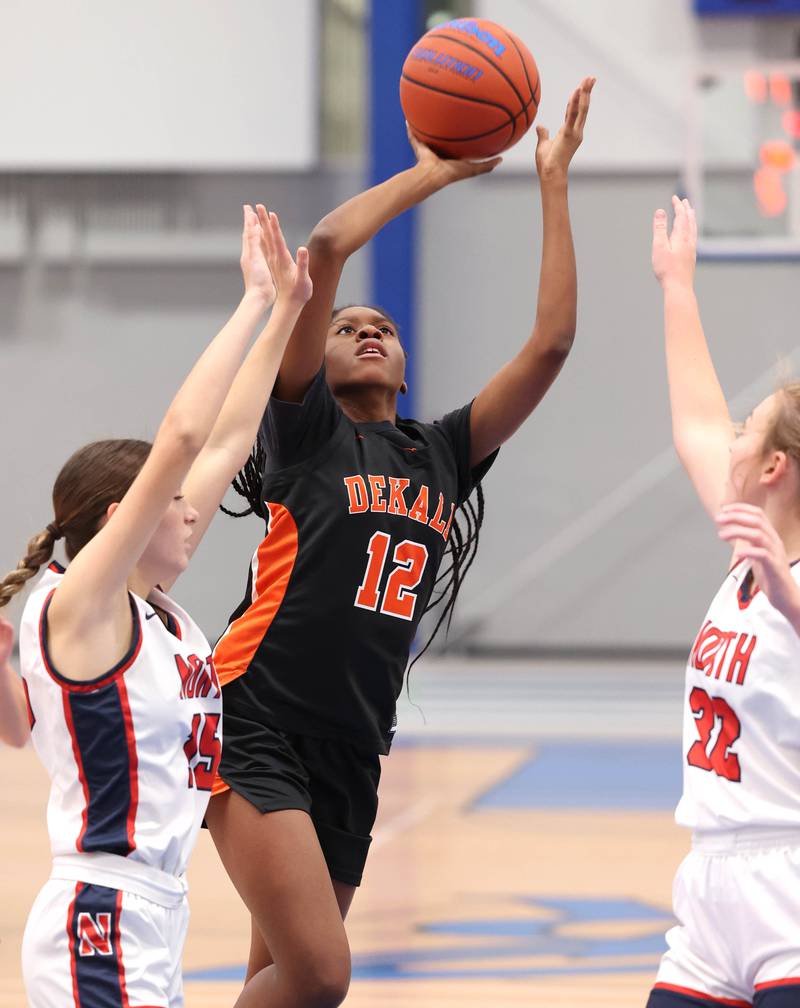 DeKalb’s Brytasi Long shoots between two Belvidere North defenders during their game Friday, Nov. 17, 2023, in the Mark Einwich Varsity Girls Basketball Rockets Kickoff Tournament at Burlington Central High School.