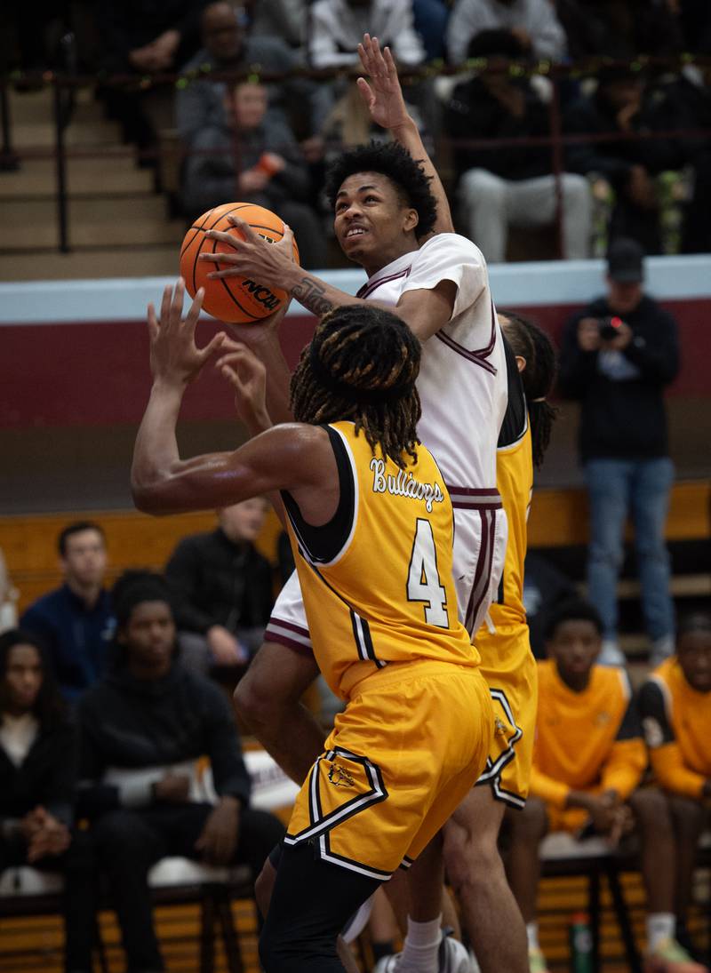 Kankakee's Clarence Shipp elevates for a shot as Richards's Travon Gourdine, front, guards in the Kankakee Holiday Tournament on Saturday, December 27, 2025.