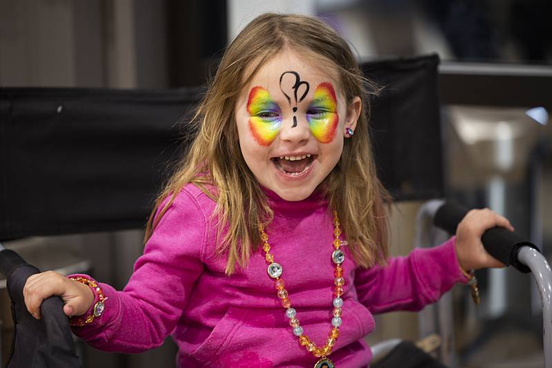 Emory Morgan, 3, of Dixon smiles at the start of her butterfly face paint by artist Kenia Guerin Tuesday, April 2, 2024 during a show by Cirque Luz Dalia at Dixon Park District’s The Facility.