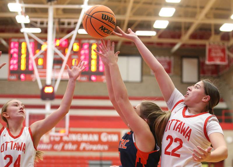 Ottawa's Marlie Orlandi tips the ball away from Pontiac's Viniece Johnson as teammate Ashlynn Ganiere looks to pick up the loose ball during the Ottawa Girls Holiday Tournament on Monday, Dec. 16, 2024 in Kingman Gym at Ottawa High School.