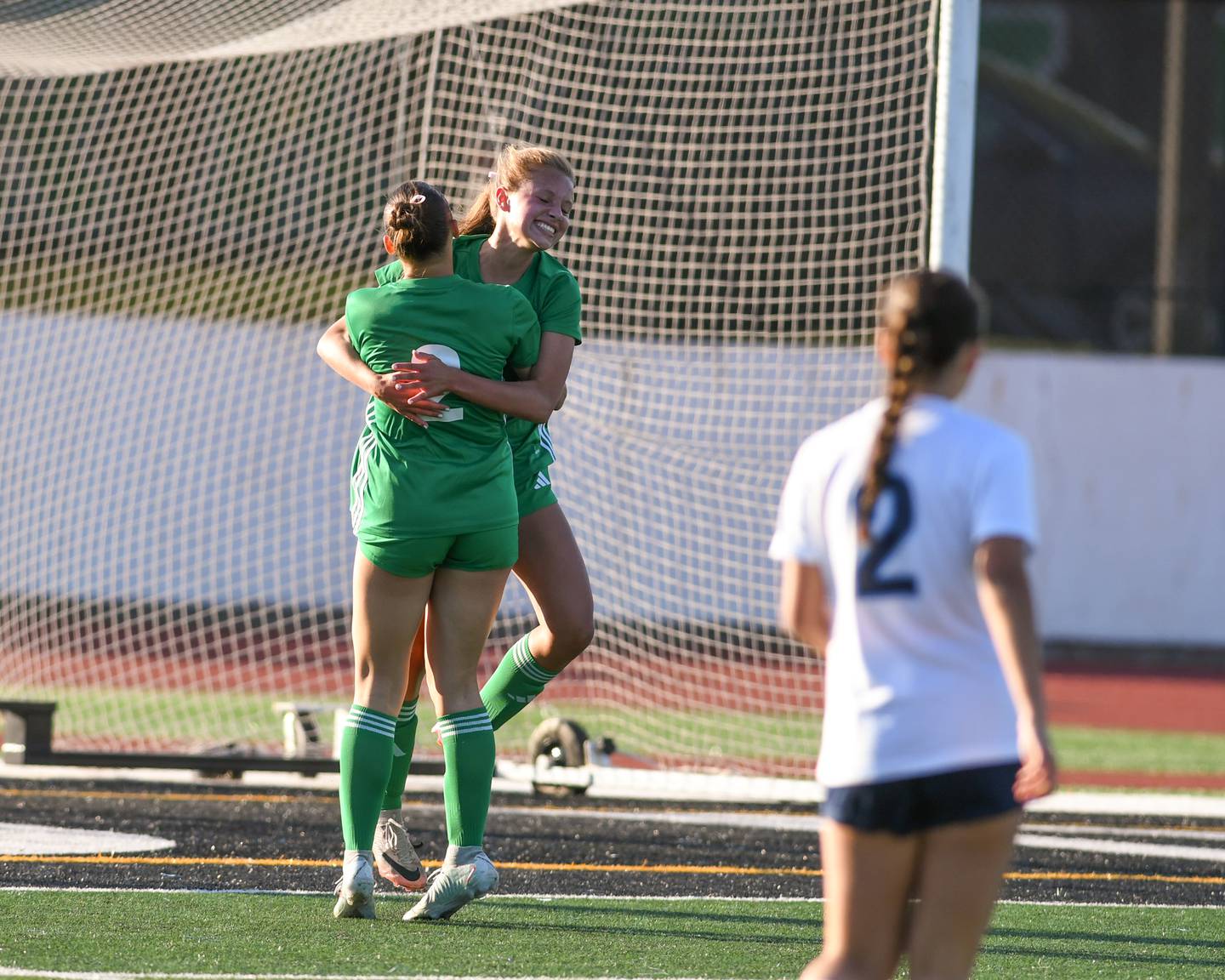 York's Isabel Voirol, center, is all smile as she jumps for joy while getting a hug from teammate Cate Carter (2) after scoring a goal in the first half of the regional title game on Friday May 23, 2025, while taking on Downers Grove South at York High School.