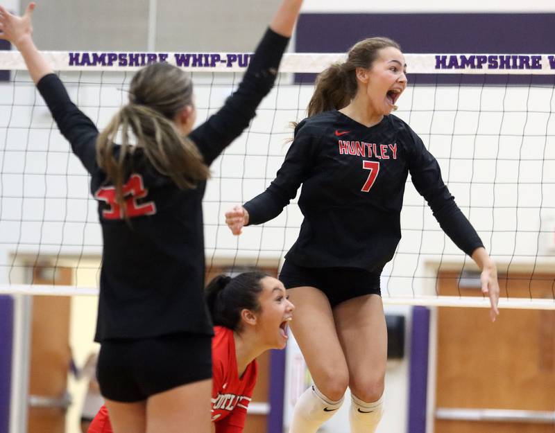 Huntley’s Mia Jacobelli and the Red Raiders get revved up after a point in varsity girls volleyball at Hampshire High School in Hampshire on Tuesday, Sept. 23, 2025.