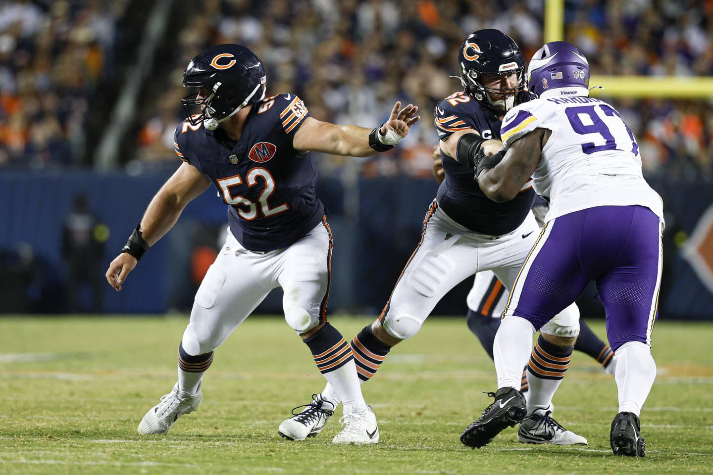 Chicago Bears center Drew Dalman (52) blocks against the Minnesota Vikings during the second half of an NFL football game, Monday, Sept. 8, 2025, in Chicago. (AP Photo/Kamil Krzaczynski)