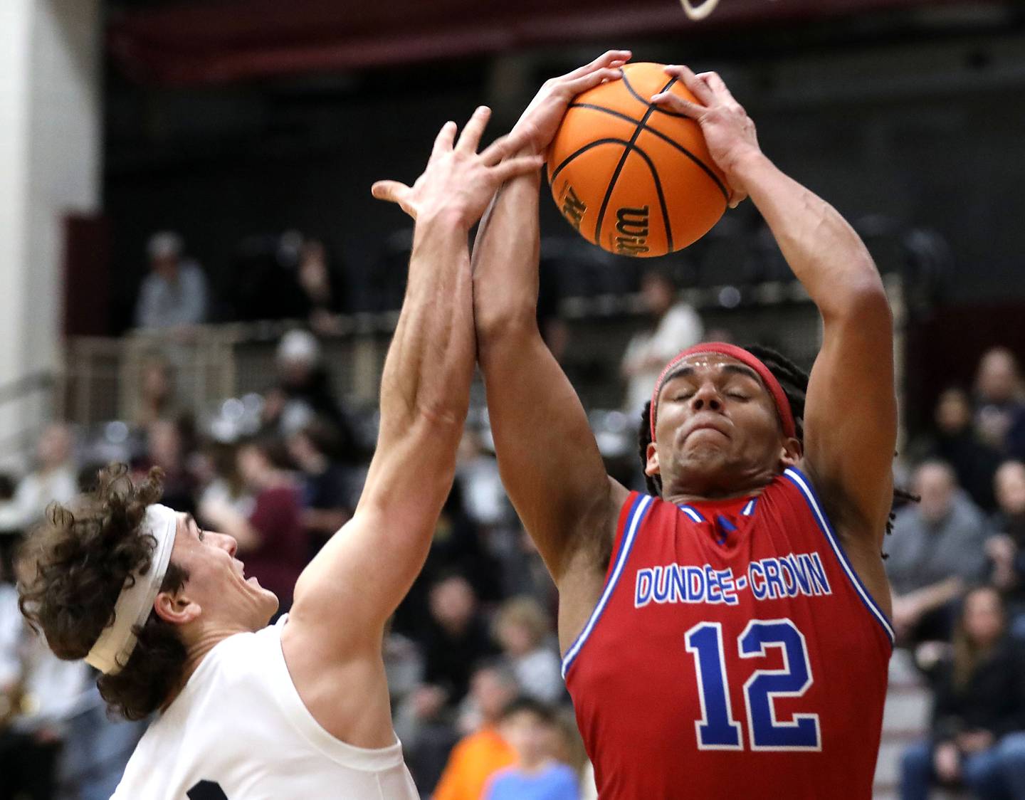 Dundee-Crown's Anthony Spain grabs a rebound in front of Prairie Ridge's Luke Vanderwiel during a Fox Valley Conference boys basketball game on Friday, Jan. 16, 2026, at Prairie Ridge High School in Crystal Lake.