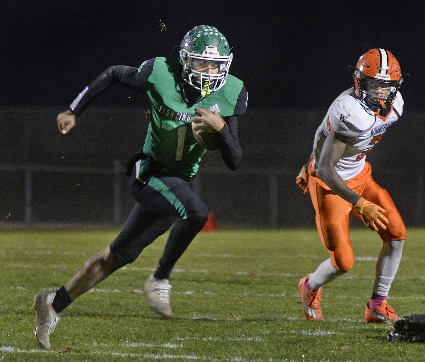 Seneca quarterback Nathan Grant (1) outruns Winnebago’s Eden Trotter on a keeper in the first quarter during the Class 3A playoff game at Seneca on Friday, Oct. 28, 2022.