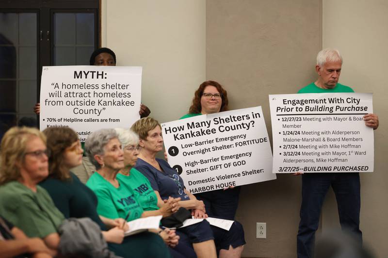 Fortitude Community Outreach supporters hold informational signs during public comment at the Kankakee City Council meeting on Monday, Sept. 15, 2025, ahead of the conditional use permit vote to allow Fortitude to operate a shelter at 970 E. Court St. in Kankakee. The conditional use permit request was rejected by a 12-0 vote.