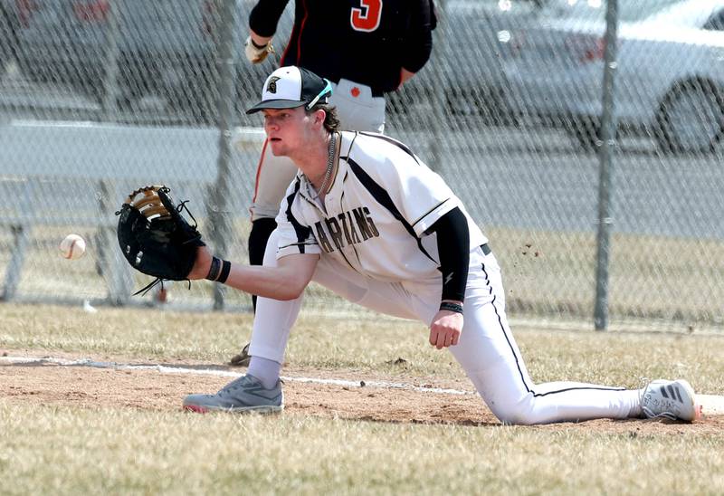 Sycamore's Davis Collie takes the throw just late as Byron’s Nolan Brass reaches first safely during their game Wednesday, March 26, 2025, at DeKalb High School. Sycamore’s home field was damaged in last week’s storms so today’s game was played on DeKalb’s field.