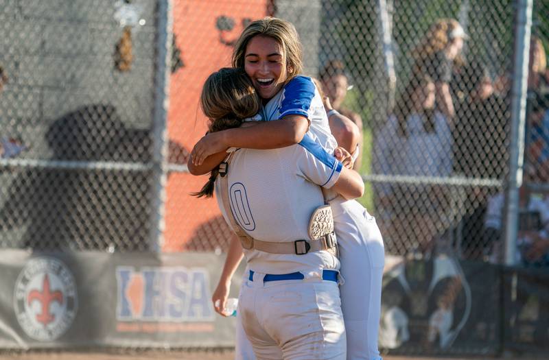 St. Charles North's Maddie Hernandez (2) is hugged by Sophia Olman (10) after driving in the game winning run on a single against Glenbard North to win the St. Charles East 4A sectional championship at St.Charles East High School on Friday, Jun 3, 2022.