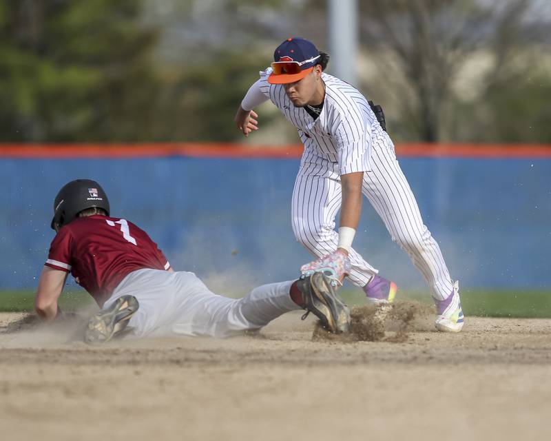 Plainfield North's Gavin Person (7) avoids the tag from Oswego's Gabe Herrera (9) at second during baseball game between Plainfield North at Oswego, Thursday, April 24, 2025 in Oswego.