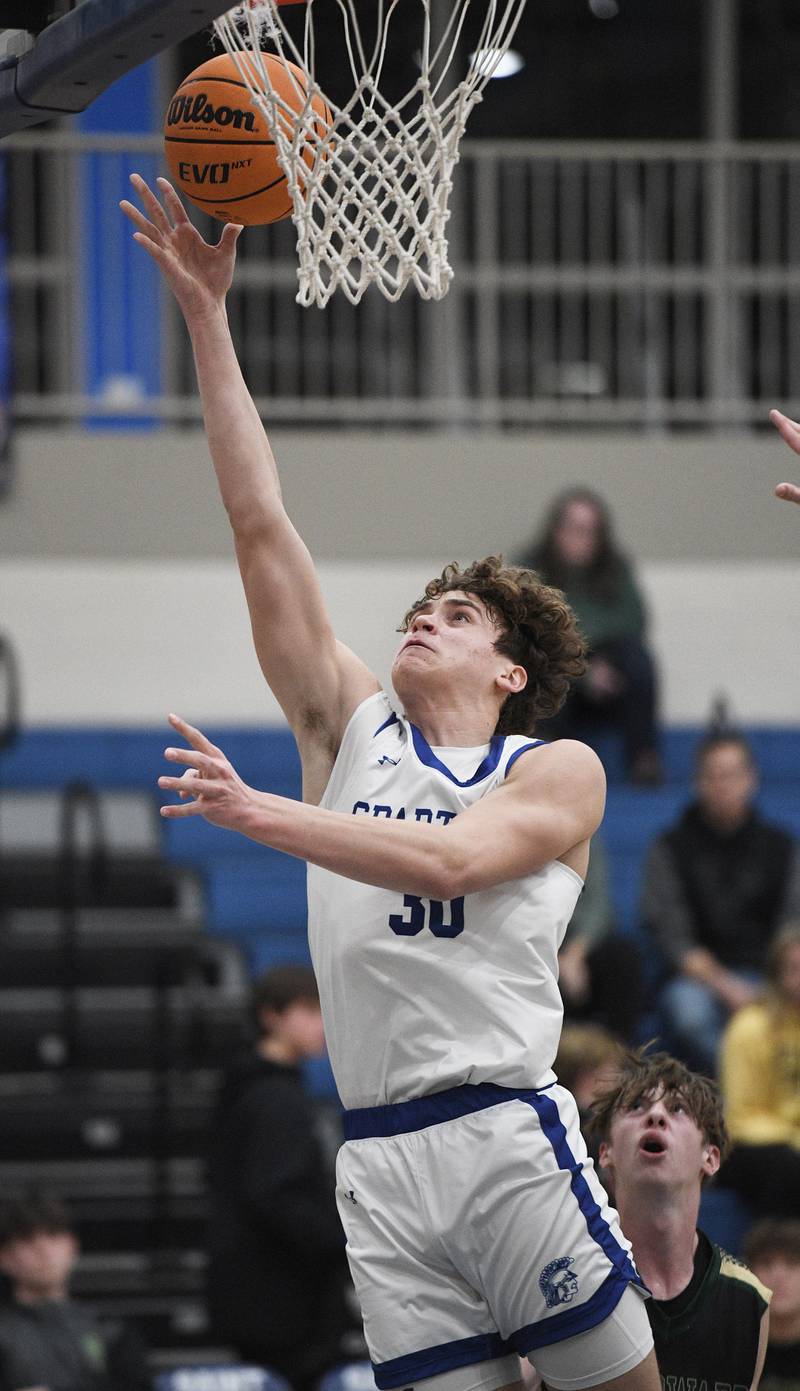St. Francis’ Gavin Mueller lays up against St. Edward in a boys basketball game in Wheaton on Tuesday, December 6, 2022.