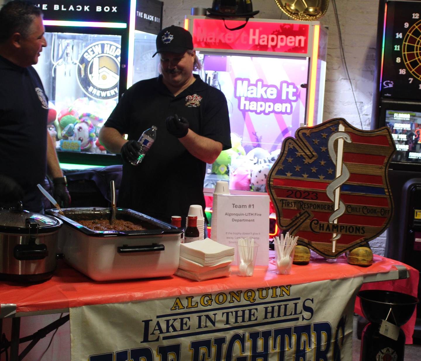 Algonquin-Lake in the Hills Fire Protection District Lieutenant Brad Avi (right) serves his award-winning chili.