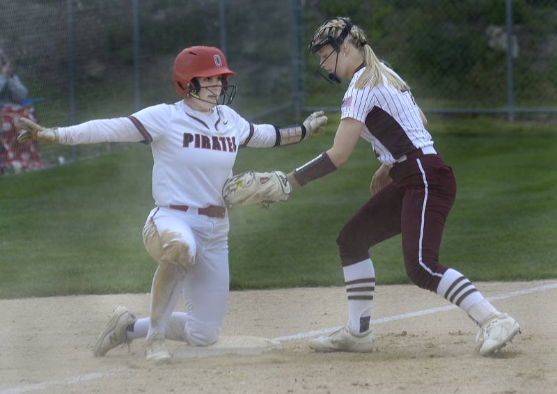 Ottawa’s Kendall Lowery signals herself safe as she gets into 3rd base with a triple before the tag by Morris’s Karson Dransfield n the first inning Wednesday at Ottawa.