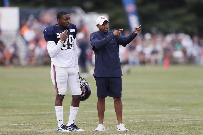 Sean Desai speaks with safety Eddie Jackson during training camp in 2019 in Bourbonnais.