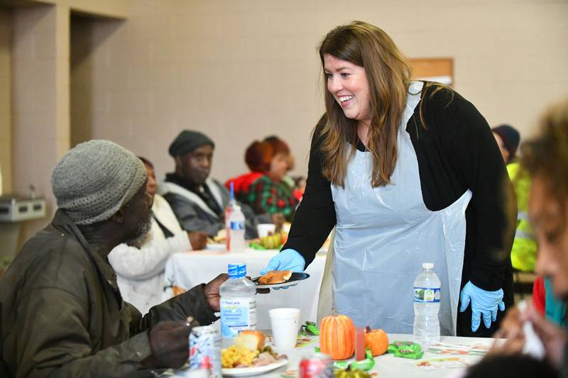 Jennifer Murakas, of Bourbonnais, delivers a slice of pumpkin pie to an attendee on Wednesday during the Kankakee Salvation Army’s annual Thanksgiving meal. Murakas has been volunteering for 10 years alongside her now-adult children, Sophia and Nick.