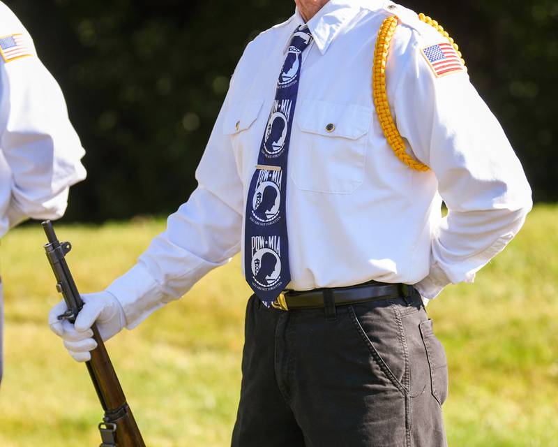 DeKalb’s American Legion honor guard member wears a tie honoring prisoners of war and those who died in action during a dedication ceremony marking the completion of phase one of the DeKalb Elks Veteran’s Memorial Plaza in DeKalb Saturday, Oct. 1, 2022.