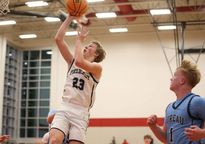 Fieldcrest's Jordan Heider eyes the hoop after running in the lane past Bureau Valley's Bryce Helms during the 50th annual Colmone Classic on Monday, Dec. 9, 2024 at Hall High School.