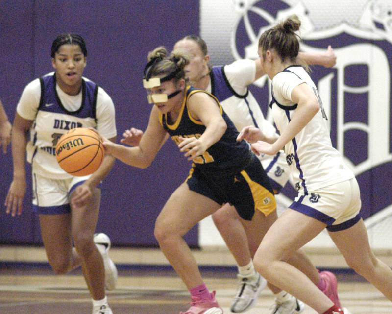 Surrounded by Dixon players, Sterlin'g's Jai James brings the ball up. Dixon and Sterling girls basketball teams played in the 3rd place game of the Dixon Girls KSB Holiday Basketball Classic Saturday, Dec. 28, 2024.
