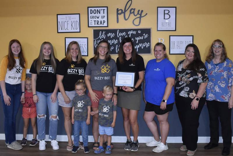 (Left to right) Iris England, Kenadee Lentman, Peyton Bradbury (activity instructor), Sarah England (H.I.V.E. lead instructor), Dawsen Lentman, Haley Lentman (owner), Foster Lentman, Courtney Levy (chamber executive director), Megan Wright (Chamber member services coordinator), Tara Bedei (Streator mayor) and Judy Booze (chamber ambassador) celebrate Bizzy Bee Activity and Learning Center's selection as Business of the Month for July 2022.