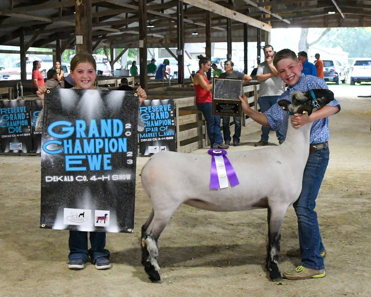 Faith, 10, and brother Westin Poynter, 11, of Maple Park hold up their grand champion awards after winning their division at the DeKalb County 4-H sheep showing held on Friday, Aug. 4, 2023 held at the Sandwich fairgrounds.