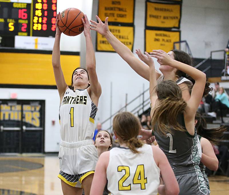 Putnam County's Ava Hatton grabs a rebound over Midland defenders during the Class 1A Regional game on Monday, Feb. 13, 2023 at Putnam County High School.