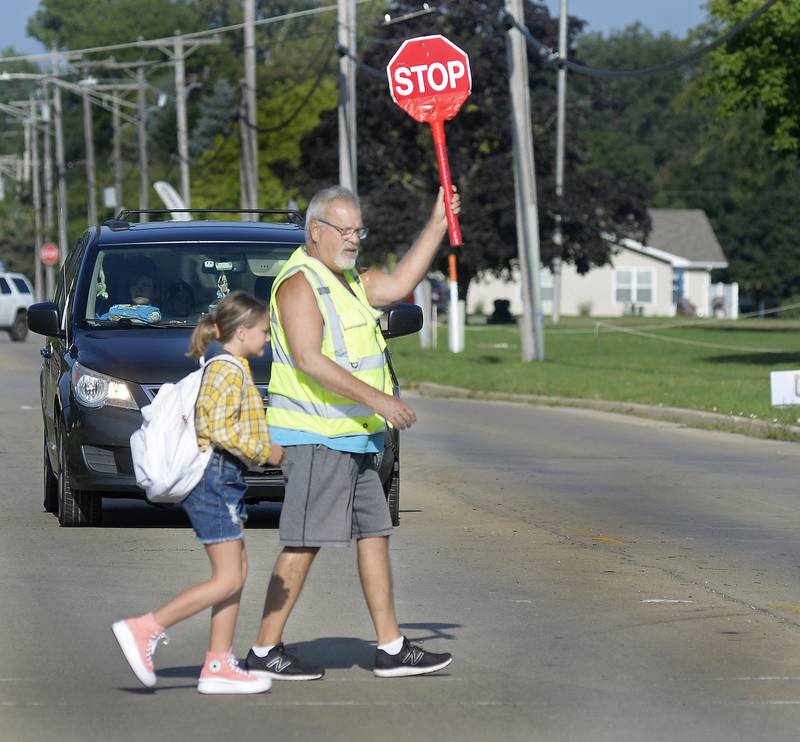 Crossing Guard Craig Shimkus leads students across Oakley Avenue as the school year started Wednesday, Aug. 16, 2023, at Centennial School in Streator.