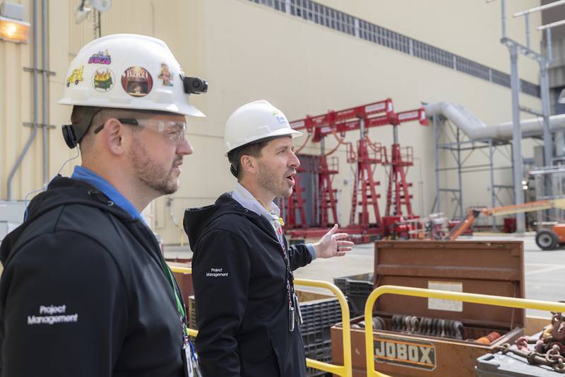 Project Manager Andy Klietz (right) talks about the logistics it takes to move a giant Unit Auxiliary Transformer (UAT) out of one of the plants Wednesday, April 16, 2025, at Byron. The transformer is being replaced with a new one.