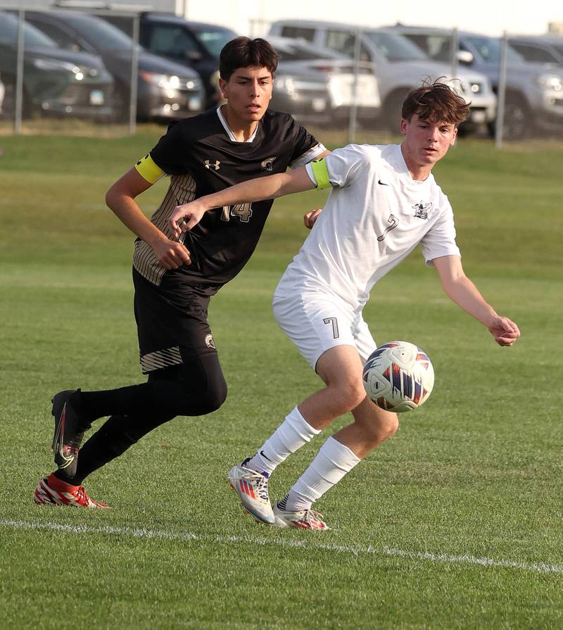 Sycamore's Javier Lopez (left) and Kaneland's Cameron Guernon go after a loose ball during their game Wednesday, Sept. 18, 2024, at Sycamore High School.