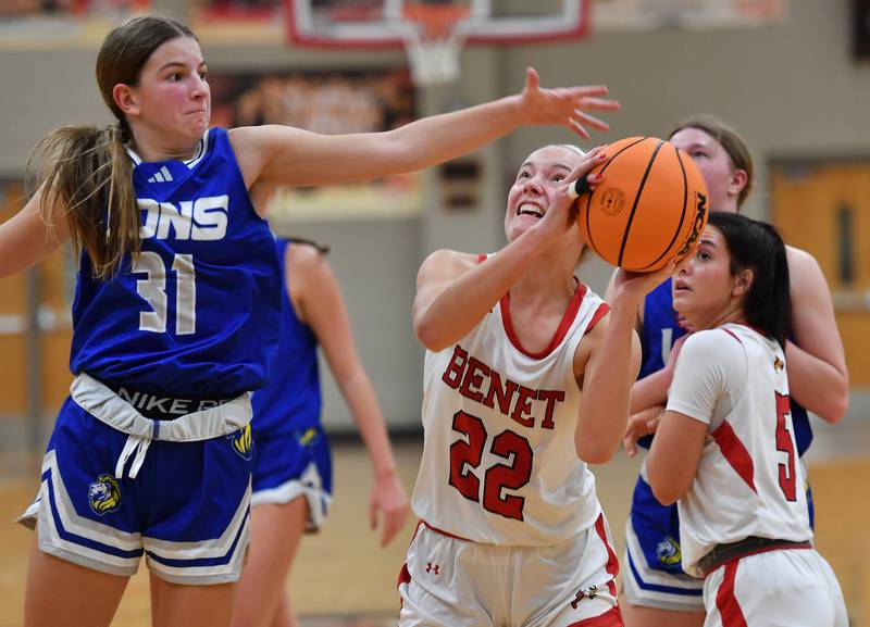 Benet’s Bridget Rifenburg (22) goes to the basket Lyons Township’s Benet’s Evie Riopell (31) defends during a game on November 18, 2025 at Benet Academy in Lisle.