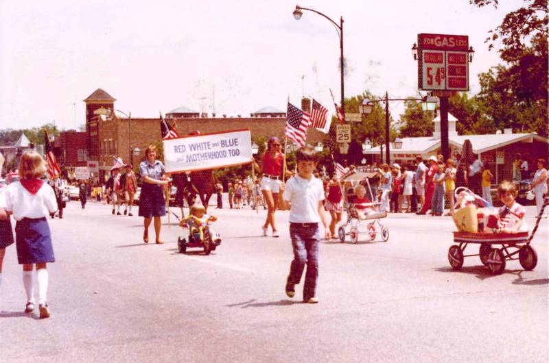 Members of the St. Charles Women's Club (then the Young Mothers Club of St. Charles) and their families participate in the 1976 bicentennial parade in downtown St. Charles.