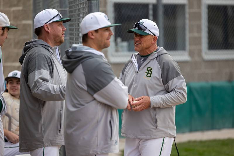 St. Bede Coaches speak between innings on Thursday, April 10, 2025 at St. Bede High School in Peru.
