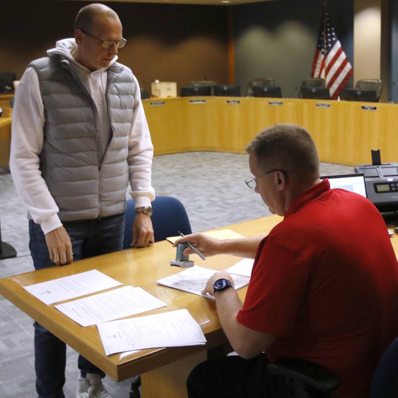 McHenry Mayor Wayne Jett files his paperwork Tuesday, Nov. 12, 2024, to run for another term as mayor of McHenry with McHenry Deputy Clerk Monte Johnson during first day of filing for the consolidated election on April 1, 2025.
