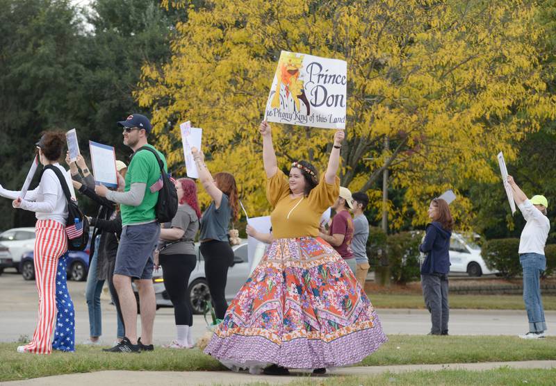People including Jessica Johnson of Wheaton participate in the No Kings Day Rally in Lisle Saturday Oct 18, 2025. This group meets along Ogden and Naperville Rd every Saturday.