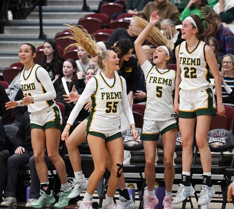 Fremd players including Coco Urlacher (11),  Greta Thompson (55), Ellie Thompson (5) and Ella Todd (22) celebrate after a player off the bench hit a three-point shot during the Hersey Class 4A supersectional against Glenbard West at Forest View Education Center on Monday, March 3, 2025 in Arlington Heights.